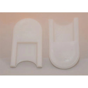 Two white U-shaped objects on a light pink background