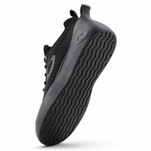 Load image into Gallery viewer, A black curling shoe shown from a side angle, highlighting its textured black sole with wavy grooves and a subtle circular logo on the side, set against a plain white background.