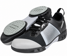 Load image into Gallery viewer, A pair of Ashwam athletic shoes in black and white, showing both the side profile and the textured outsole with grey grip pads.